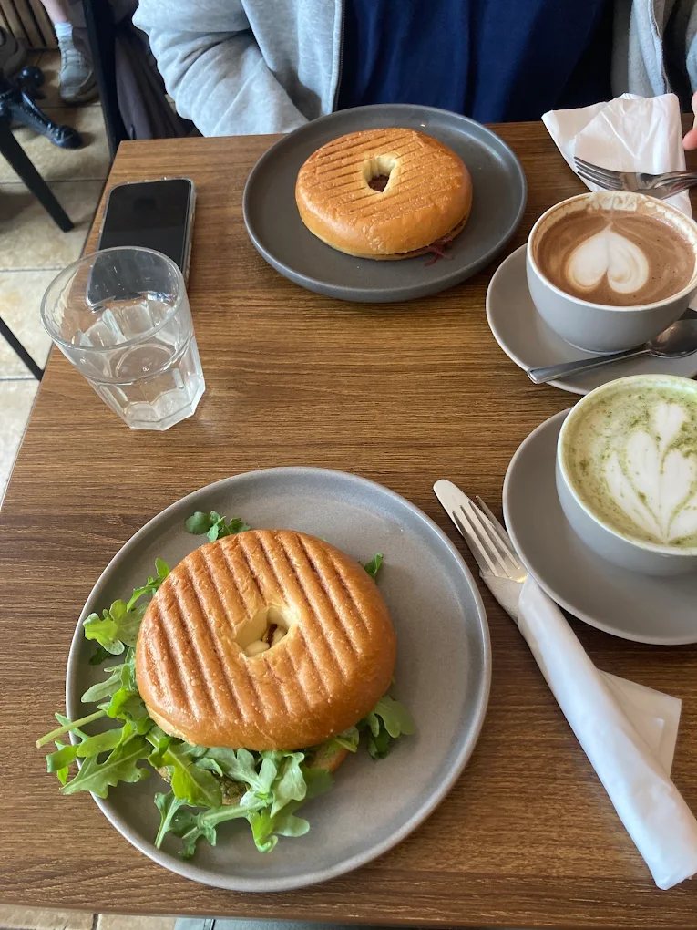 Toasted bagels with a mocha and a matcha latte